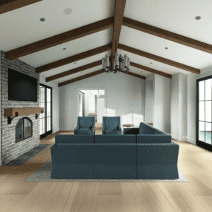 A modern farmhouse living room with wooden beams on the ceiling, large windows, a brick fireplace, a wall-mounted TV, and a blue sectional sofa. Light streams in from the large glass doors on both sides.