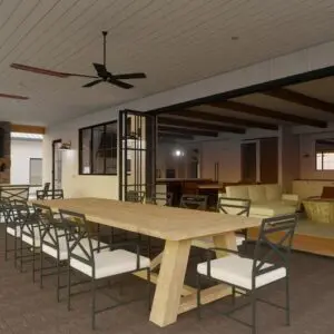 A spacious outdoor patio with a long wooden dining table, chairs, ceiling fan, and a fireplace. The modern farmhouse area is connected to an indoor living space through large glass doors.