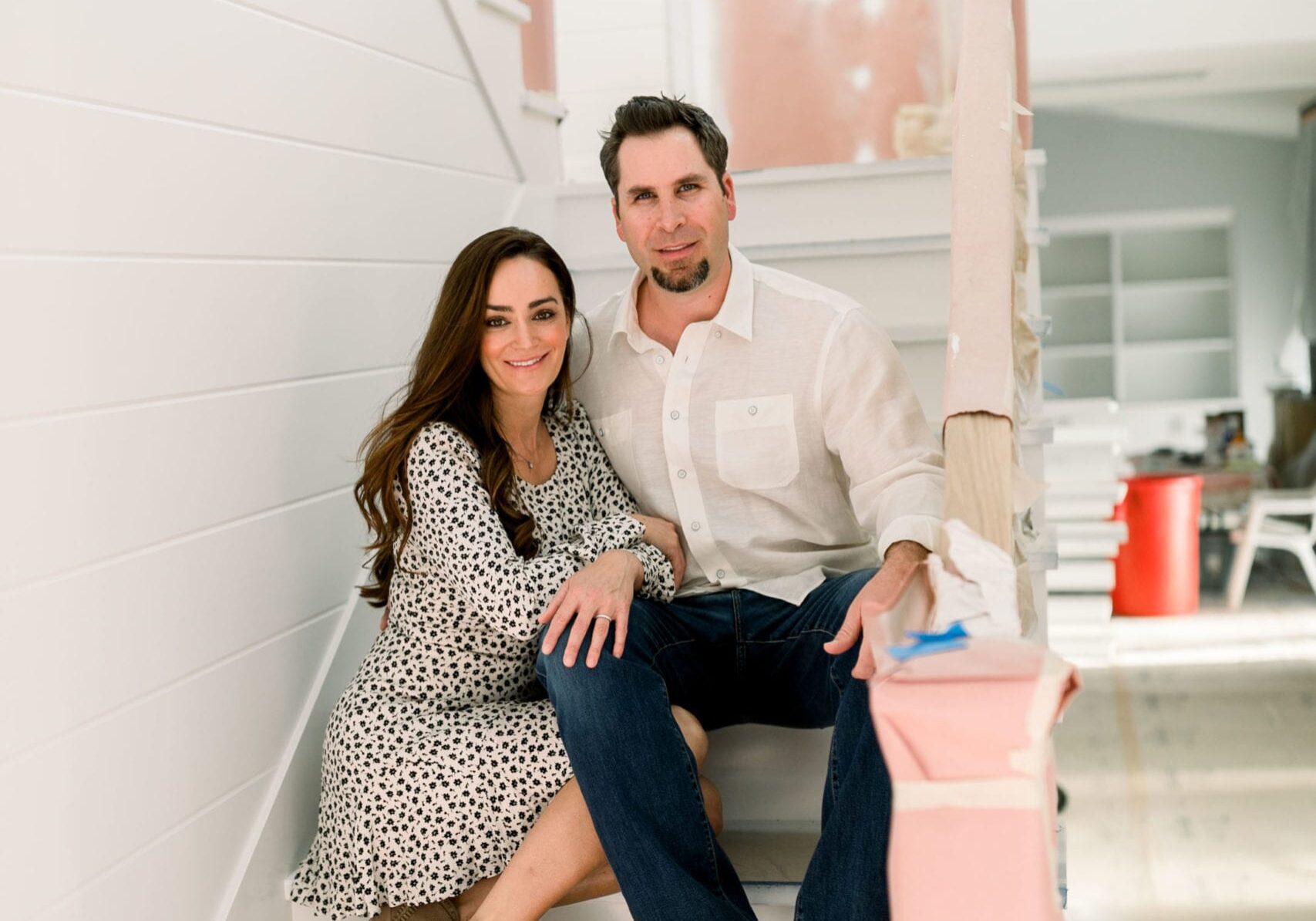 Lori and Justin on stairs in a project currently under construction 2020 our story